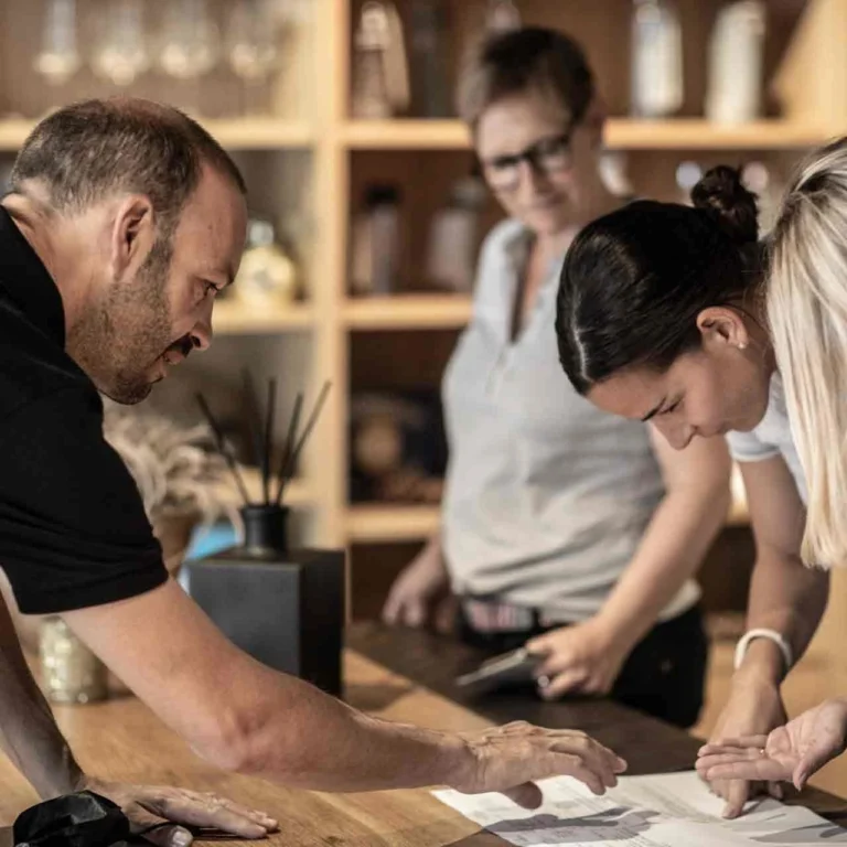 Hotel Grischa team members working together at a wooden table