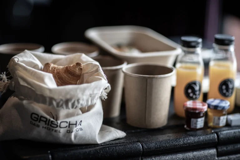 Hotel Grischa brunch box with Gipfeli in a fabric bag, coffee cups and juices