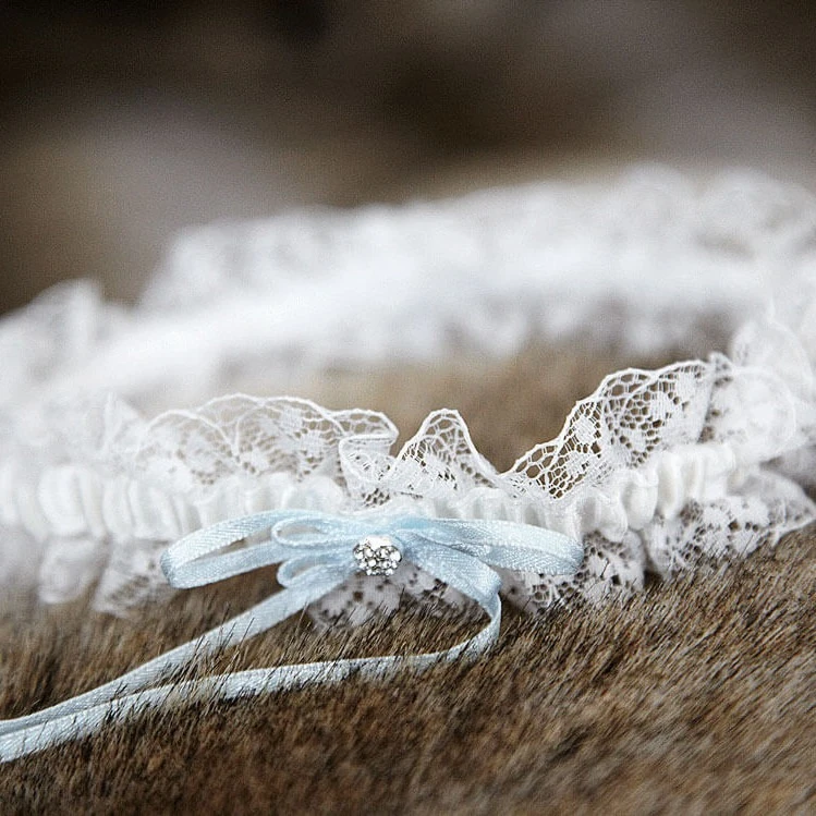 White lace garter with light blue bow on fur