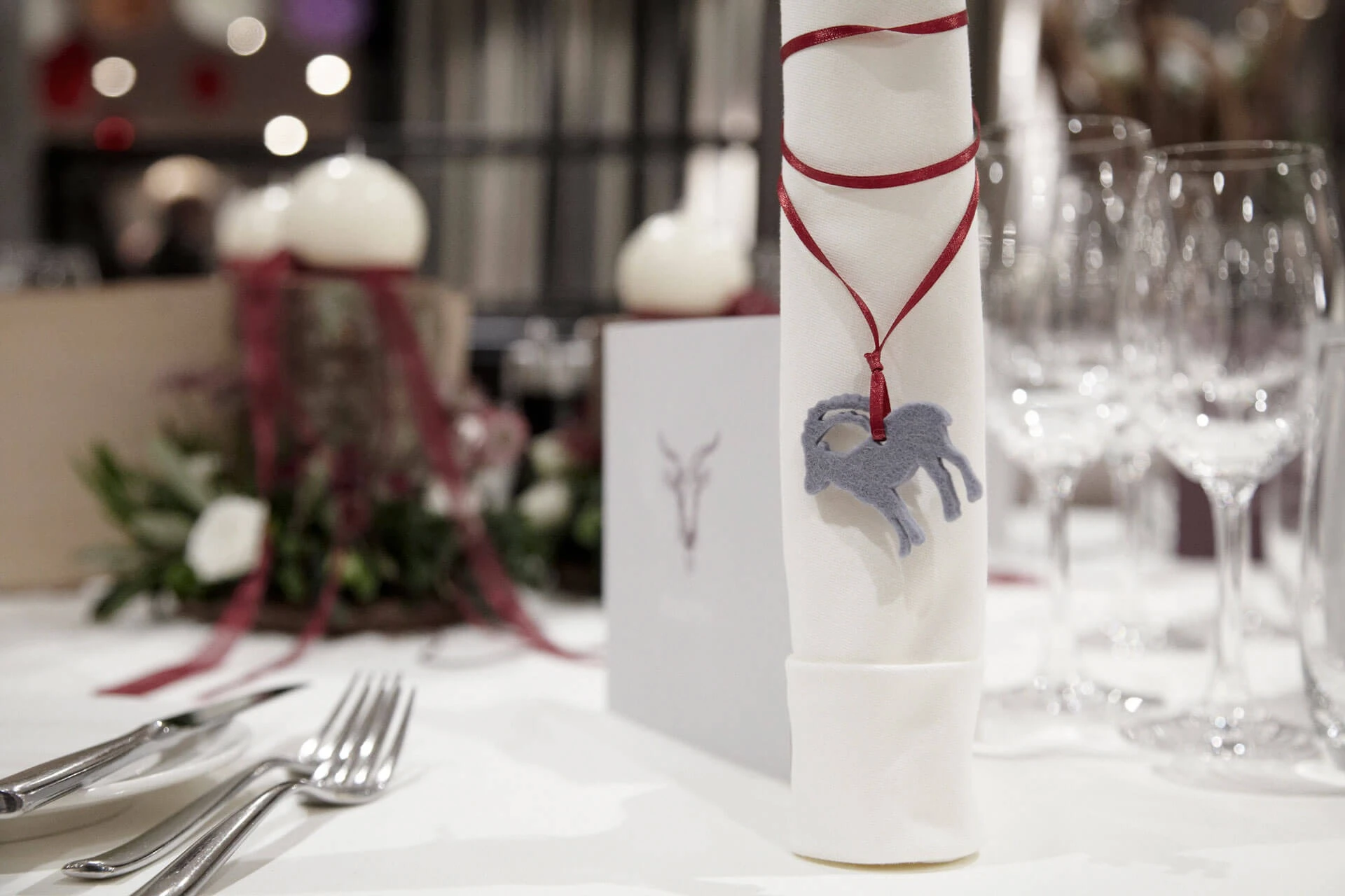 Festlich gedeckter Tisch mit Steinbock-Anhänger an der Serviette