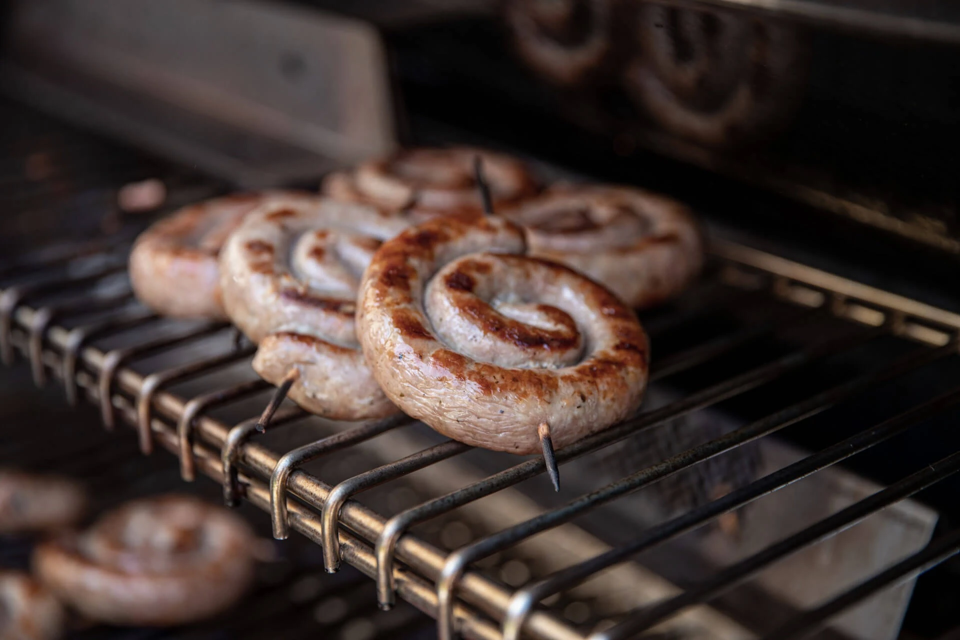 Gegrillte Bratwurstschnecken auf dem Grillrost