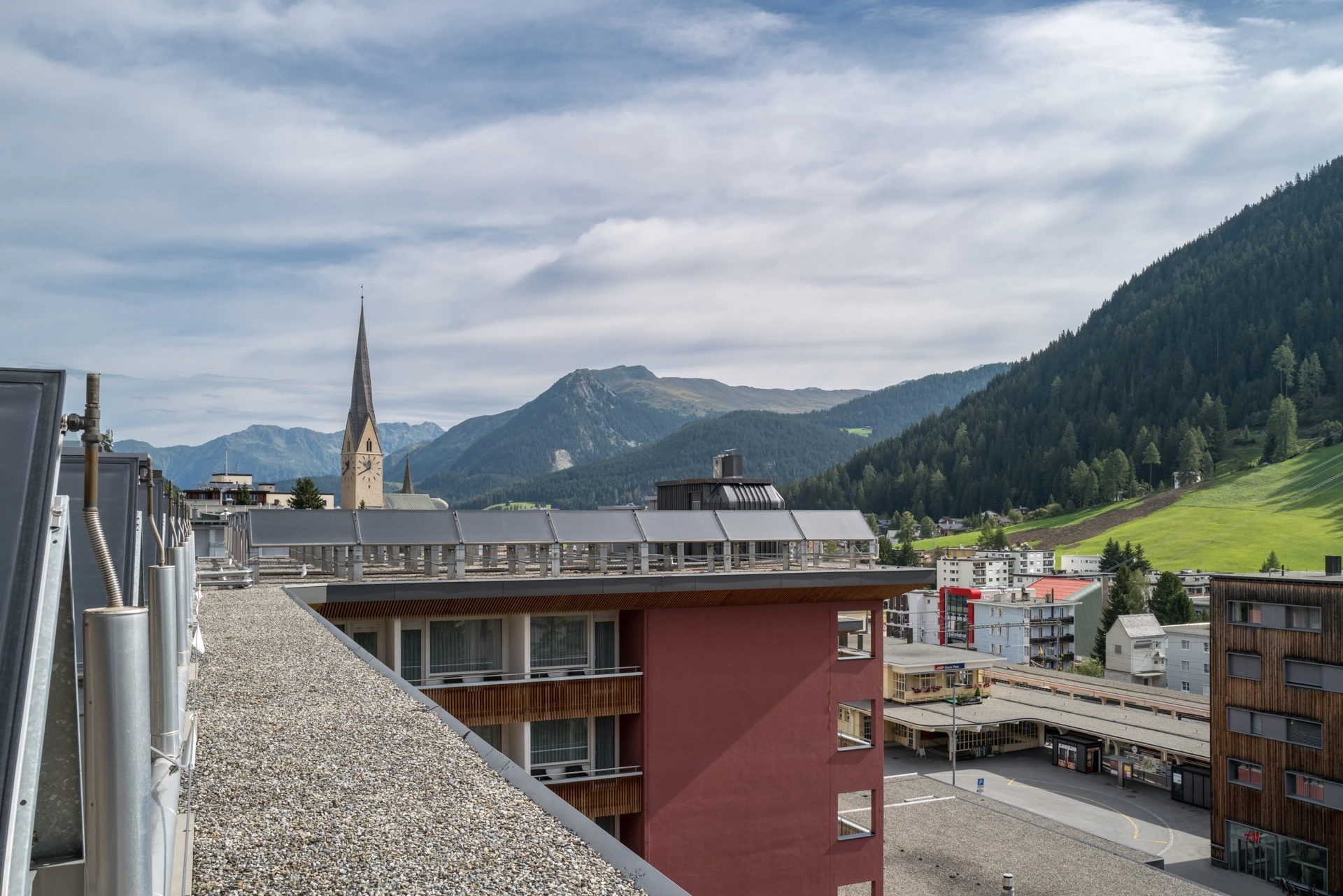 View from the roof of Hotel Grischa over Davos with church tower and mountains